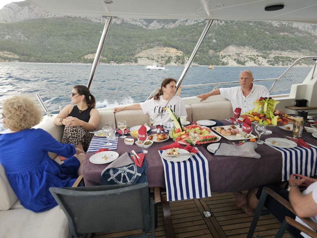 a group of people sitting at a table on a boat