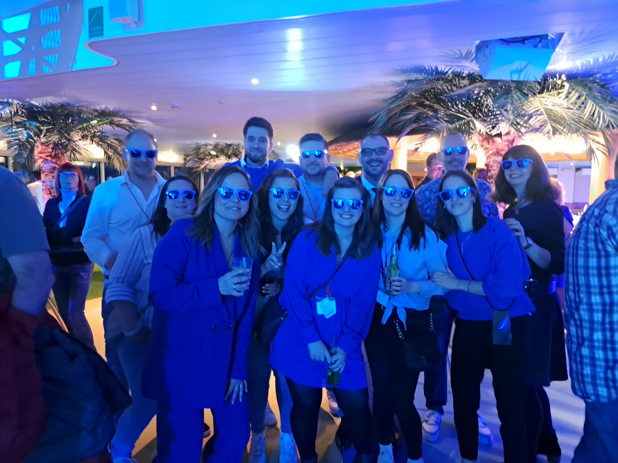 a group of people wearing blue sunglasses