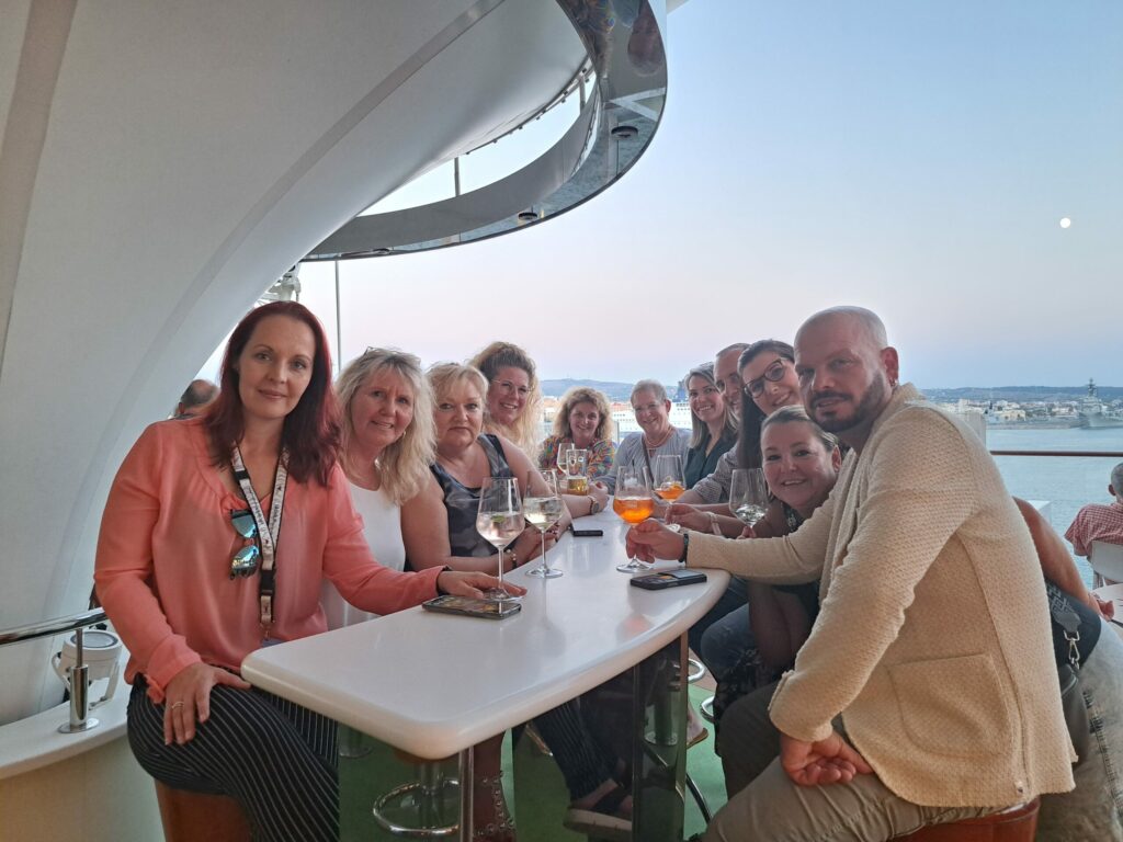 a group of people sitting at a table with drinks