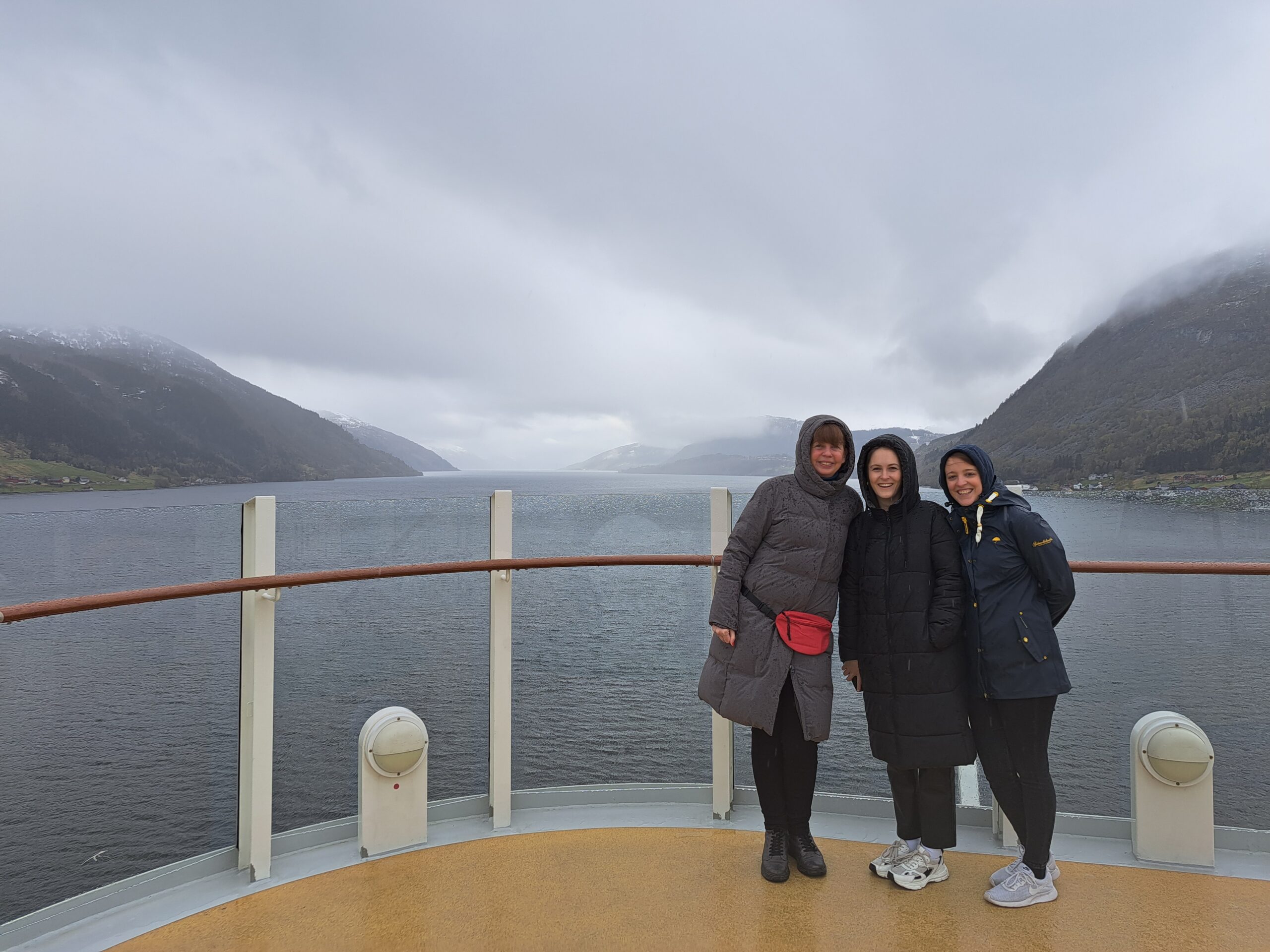 a group of women standing on a deck of a ship
