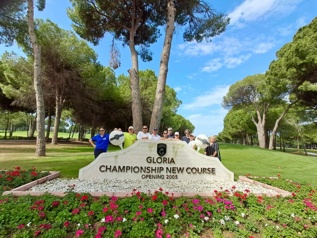 a group of people standing in front of a sign