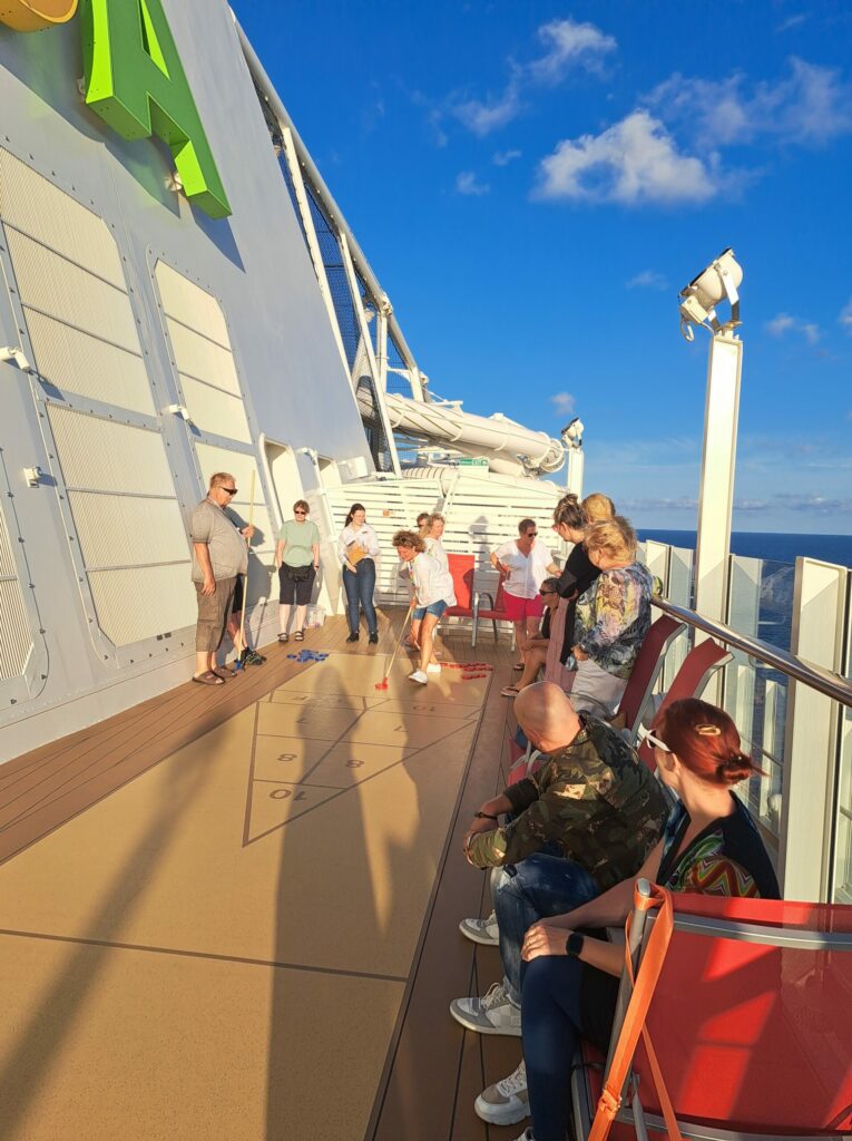 a group of people on a deck of a cruise ship
