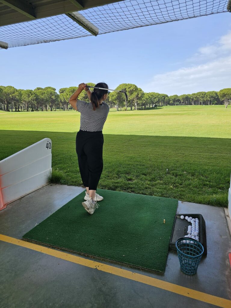 a woman swinging a golf club