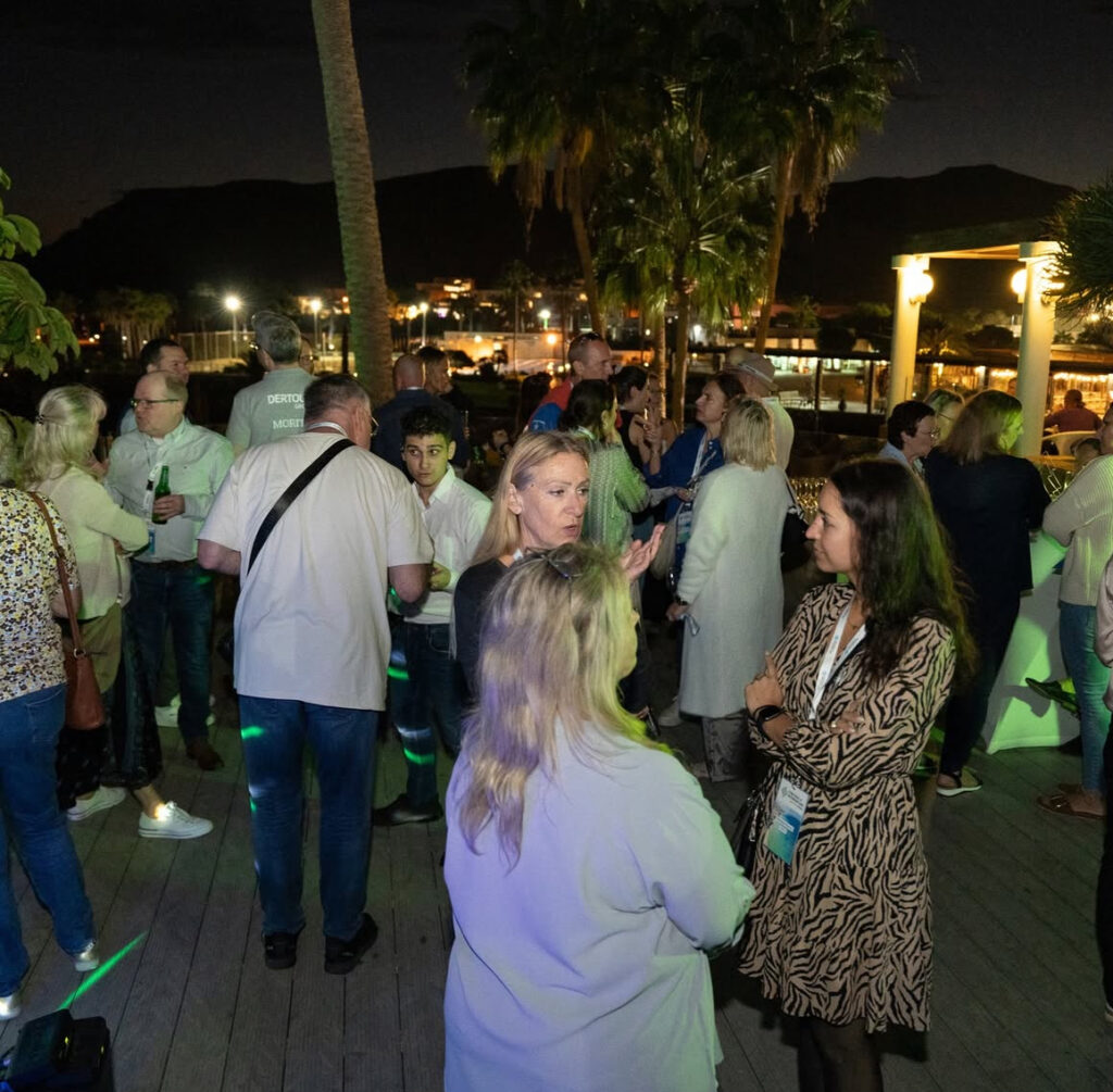 a group of people standing outside at night