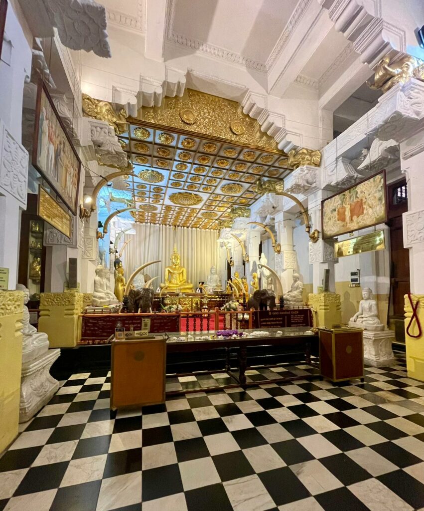 a room with a black and white checkered floor and a gold statue
